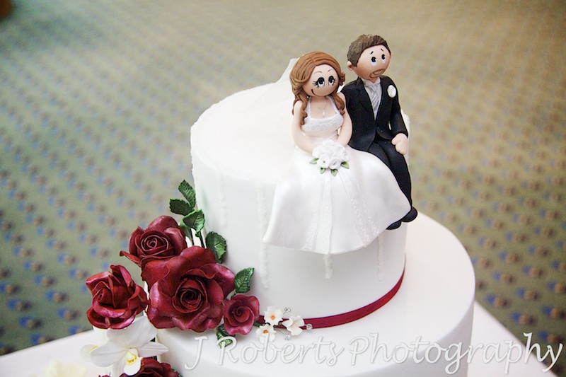 Bride and groom figurines on wedding cake -wedding photography sydney